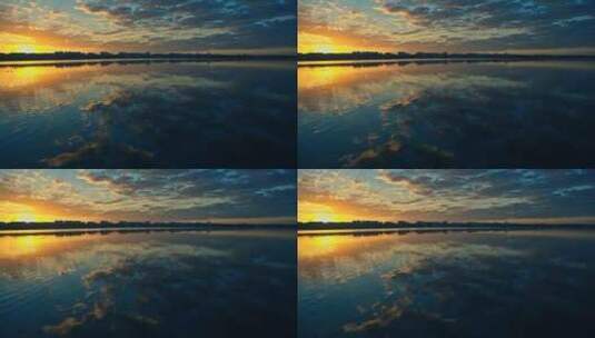 宁静湖面上的彩色橙色日落高清在线视频素材下载