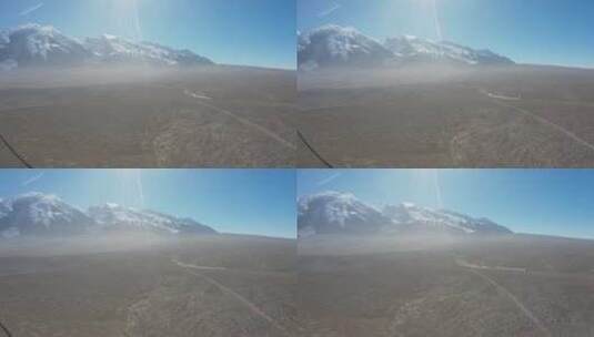 新疆正午雪山脚下飞驰过的汽车航拍高清在线视频素材下载
