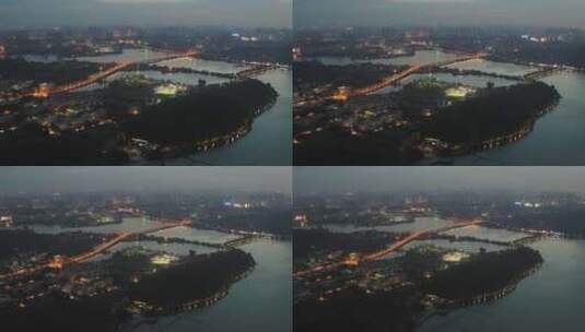 航拍武汉东湖梅园码头傍晚灯光城市桥高清在线视频素材下载