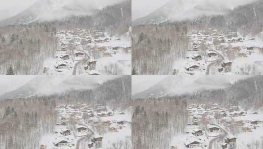 无人机镜头从下雪的滑雪村下降，雪带着低沉的云层飞向相机高清在线视频素材下载