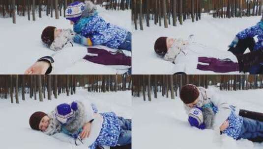 妈妈和女儿躺在雪地里玩耍高清在线视频素材下载