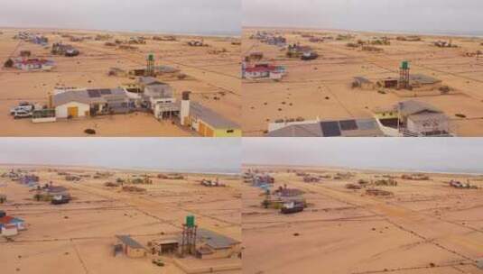 航拍沙漠上的几栋房屋建筑高清在线视频素材下载
