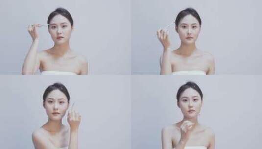 白色背景下年轻女性使用眉笔画眉补妆高清在线视频素材下载