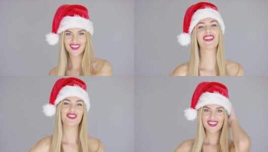 美丽的女孩戴着圣诞帽高清在线视频素材下载