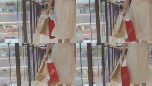 中国女性在商场购物手拎购物袋步行高清在线视频素材下载
