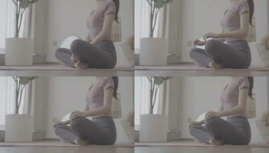 女生在瑜伽垫上呼吸冥想高清在线视频素材下载