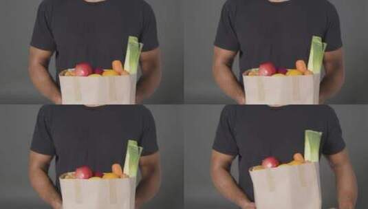 男子手持纸袋果蔬特写镜头高清在线视频素材下载