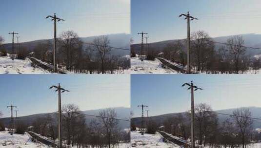 雪景下山村公路边的电线杆高清在线视频素材下载