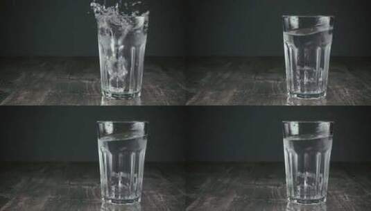 两个冰块掉进一杯水里高清在线视频素材下载
