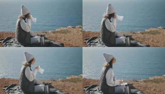 独自在悬崖边吃海洋野餐的女孩高清在线视频素材下载