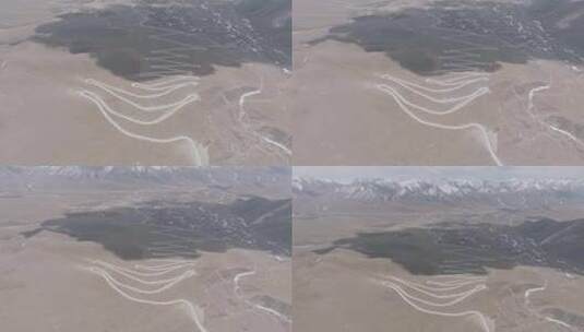 航拍西藏拉萨琼穆岗嘎雪山下的盘山公路高清在线视频素材下载