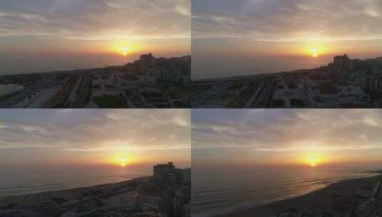日落时海滨城市的鸟瞰图高清在线视频素材下载