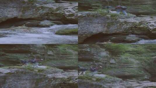 竖屏拍摄站在流水和巨石上的夫妇高清在线视频素材下载