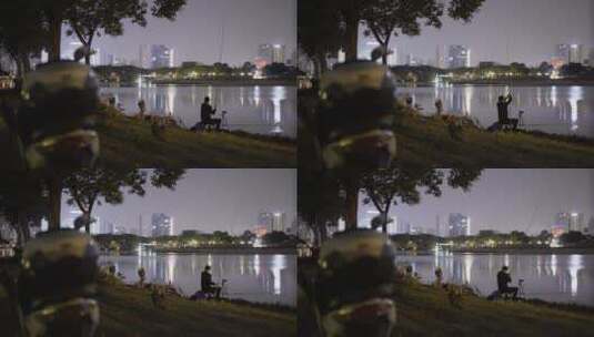 4K夜晚公园河边钓鱼的人高清在线视频素材下载