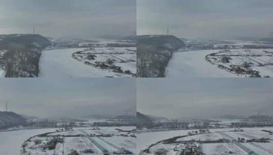 黑龙江牡丹江市被雪覆盖空旷的田地河面航拍高清在线视频素材下载
