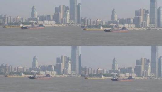 武汉江滩地拍长江江面高楼大厦货船高清在线视频素材下载