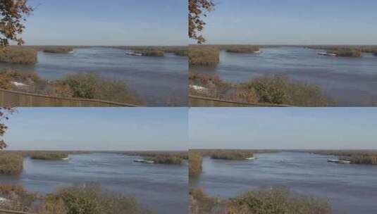 镜头调焦拍摄远处河面上的一艘船高清在线视频素材下载