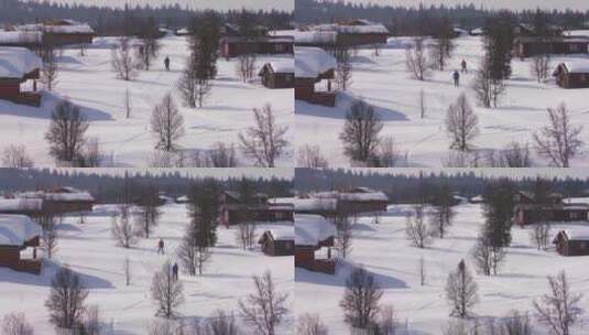 航拍越野滑雪者在村庄滑雪高清在线视频素材下载