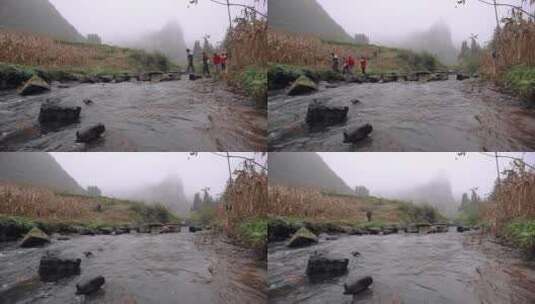 乡下农村溪流小石桥上走过的村民高清在线视频素材下载