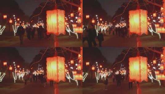 春节一群人在挂满红灯笼地路上游览高清在线视频素材下载