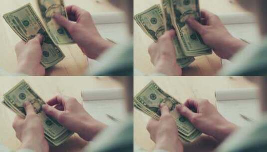一名年轻女子在纸质笔记本旁边数美元钞票的特写镜头。高清在线视频素材下载