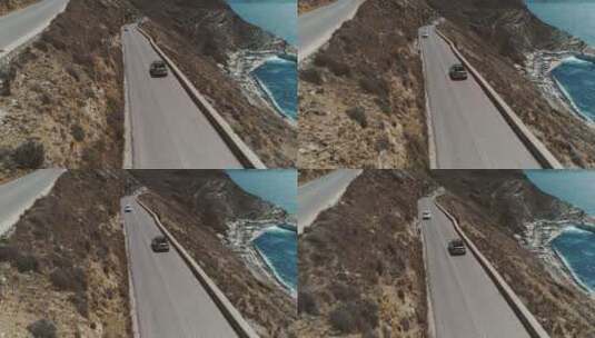 航拍海边悬崖公路上的旅游车辆高清在线视频素材下载