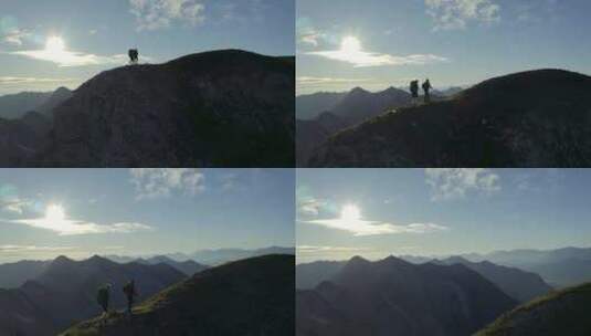 无人机略过山顶的徒步旅行者高清在线视频素材下载