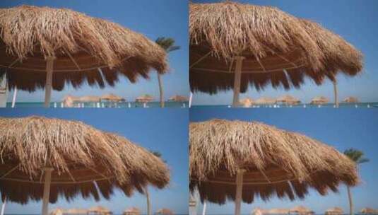 海滩上的草伞高清在线视频素材下载
