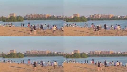落日余晖河边沙滩游玩的人高清在线视频素材下载