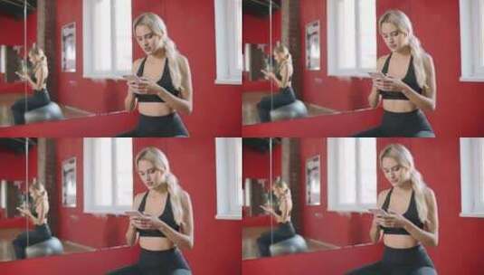 美女在健身俱乐部使用智能手机高清在线视频素材下载