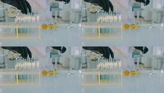 科学家将黄色液体倒入试管高清在线视频素材下载