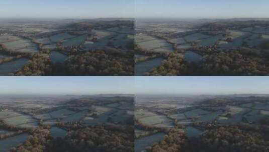 无人机在寒冷的早晨飞越乡村田野高清在线视频素材下载