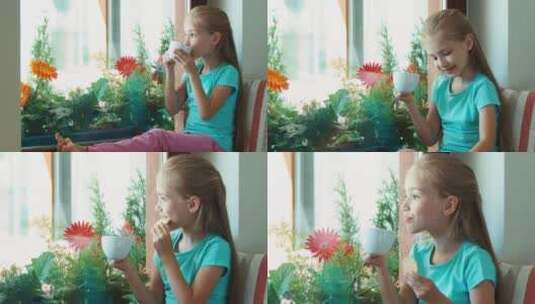 坐在窗台上吃饼干喝茶的女孩高清在线视频素材下载