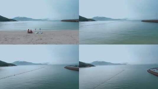 4k深圳海湾视频海滩情侣冲浪爱好者高清在线视频素材下载