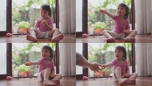 可爱的亚洲小女孩在家里玩耍分享食物高清在线视频素材下载