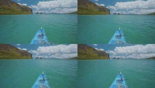 跳岛之旅蓝色小船悬停在异国岩溶石灰岩之间开阔的蓝色海洋表面高清在线视频素材下载