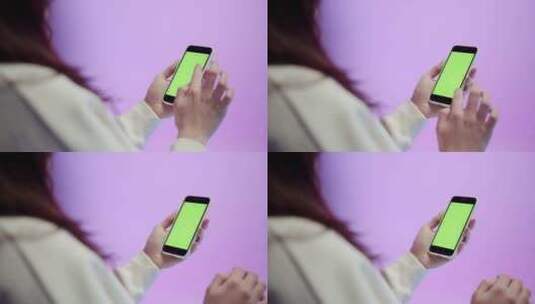 年轻女子使用带有彩色绿色按键屏幕的手机高清在线视频素材下载