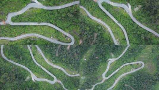 无人机拍摄的蜿蜒道路和绿色森林高清在线视频素材下载