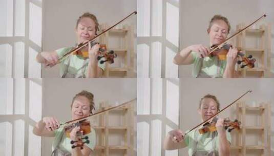 阳光明媚的日子里，快乐的女音乐家拉小提琴高清在线视频素材下载