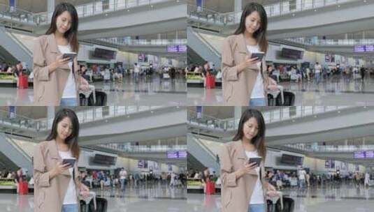 旅行妇女在机场使用手机高清在线视频素材下载
