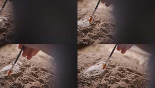 考古发掘人员用刷子轻轻扫去覆盖文物上沙泥高清在线视频素材下载