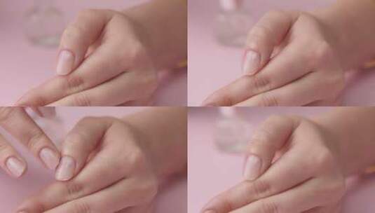 粉红色的女人为自己修指甲高清在线视频素材下载