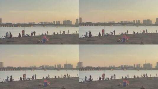 落日余晖河边沙滩游玩的人2高清在线视频素材下载