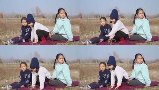 冬季在公园草坪上玩游戏的三个女孩高清在线视频素材下载