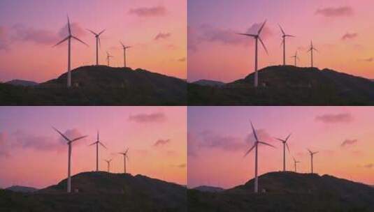 海岛晚霞中的风力发电机组高清在线视频素材下载