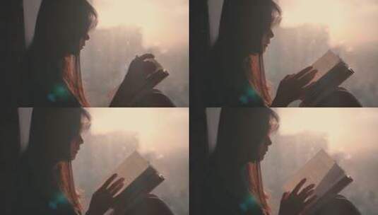 女孩在夕阳下的窗边看书阅读4k视频素材高清在线视频素材下载
