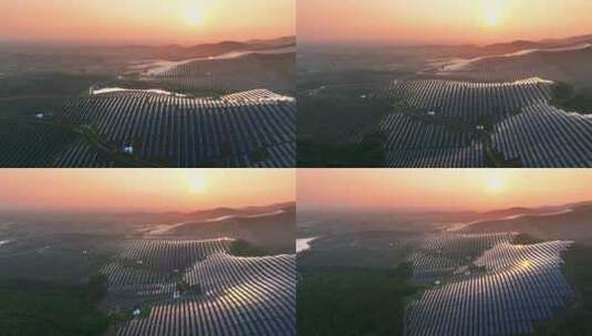 夕阳下山坡上的太阳能光伏发电站航拍高清在线视频素材下载