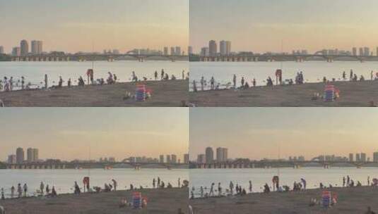落日余晖河边沙滩游玩的人3高清在线视频素材下载