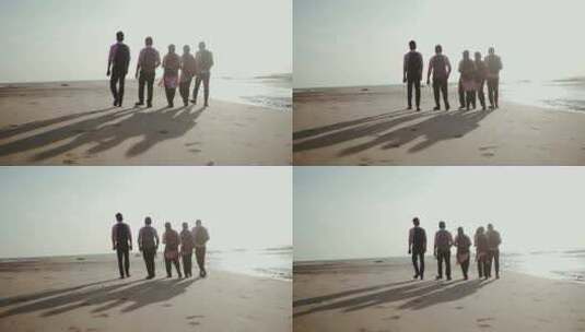 海边散步的五位游客背影高清在线视频素材下载