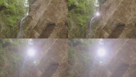 阳光穿过岩石瀑布的缝隙高清在线视频素材下载